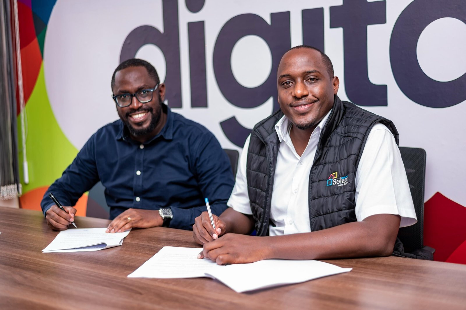 Nicholas Mugerwa MD of Solace Graphix and Ian Rumanyika Chairman of Corporate games sign MOU