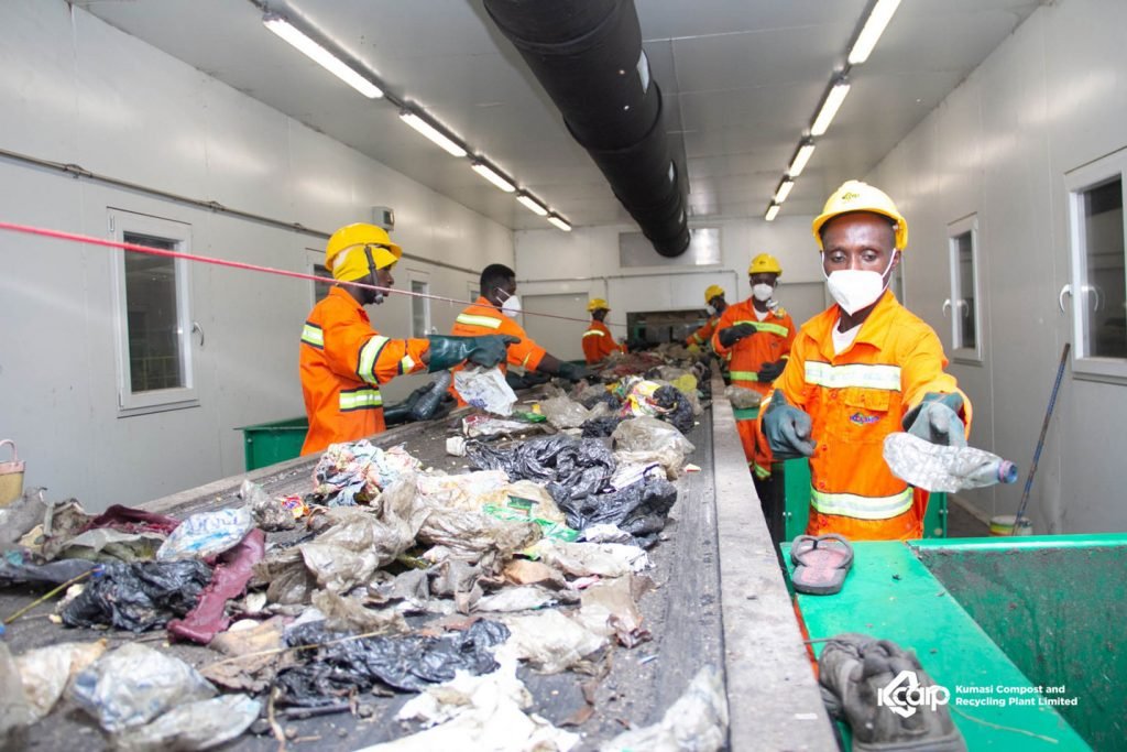 Workers sorting trash at a Jospong waste management facility