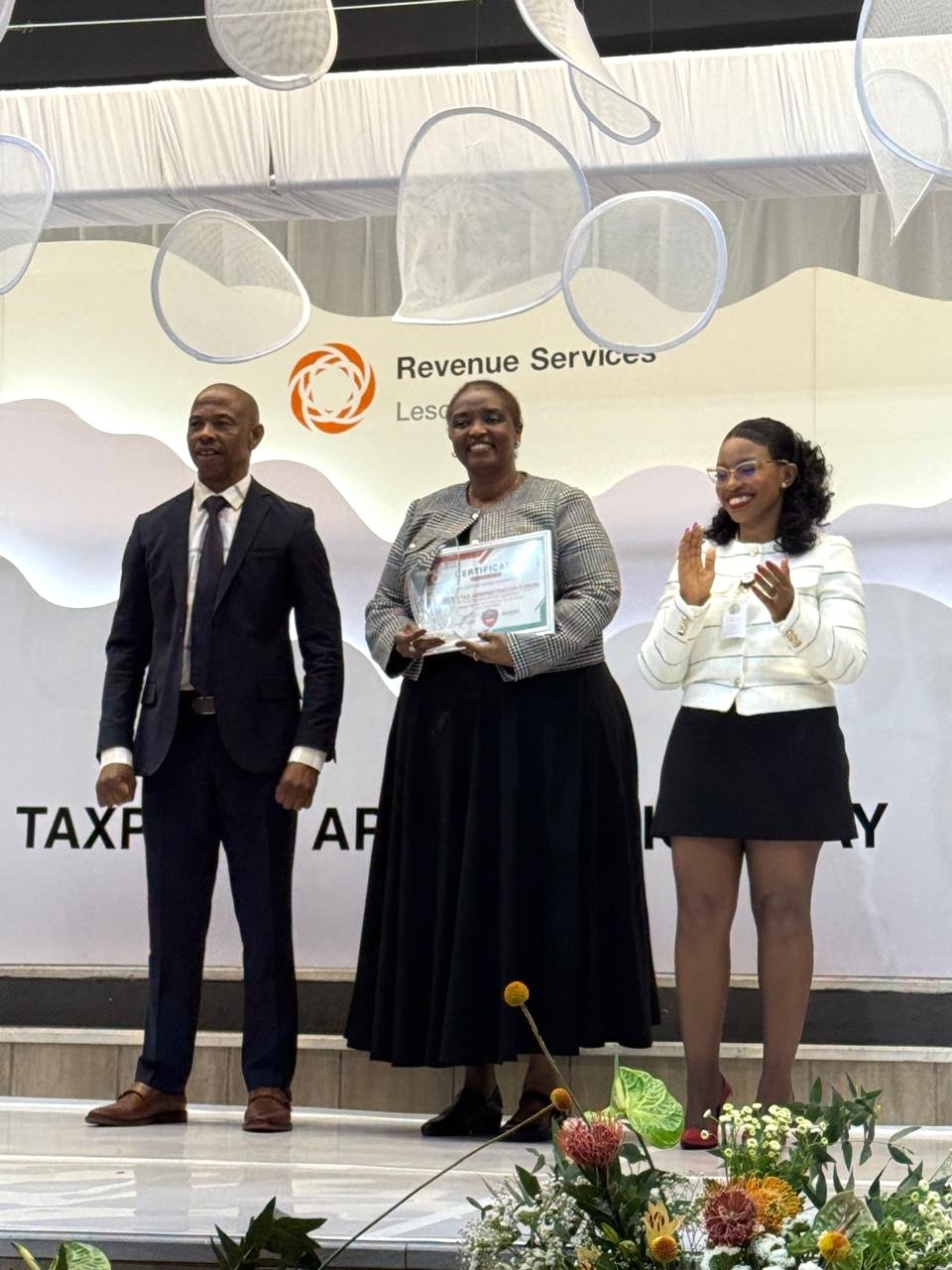ATAF Executive Director Ms. Mary Baine receives the award on behalf of ATAF from Revenue Services Lesotho ATAF Executive Director Ms. Mary Baine receives the award on behalf of ATAF from Revenue Services Lesotho