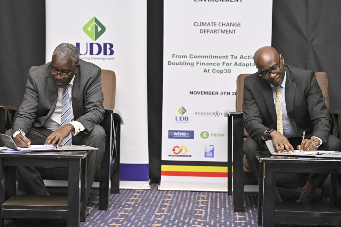 Dr. Alfred Okot Okidi (L), PS Ministry of Water and Environment and Denis Ochieng (R), UDB Director Finance and Business Operations, signing the MoU