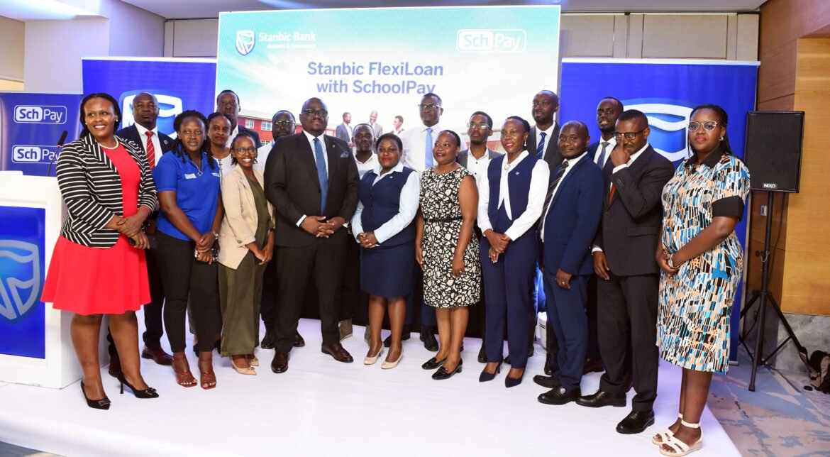 Stanbic Bank and Fincom delegations led by Tunde Thorpe, Head Business Commercial Banking and Joseph Ndiho, Board Chair pose for a group photo during the event launch in Kampala