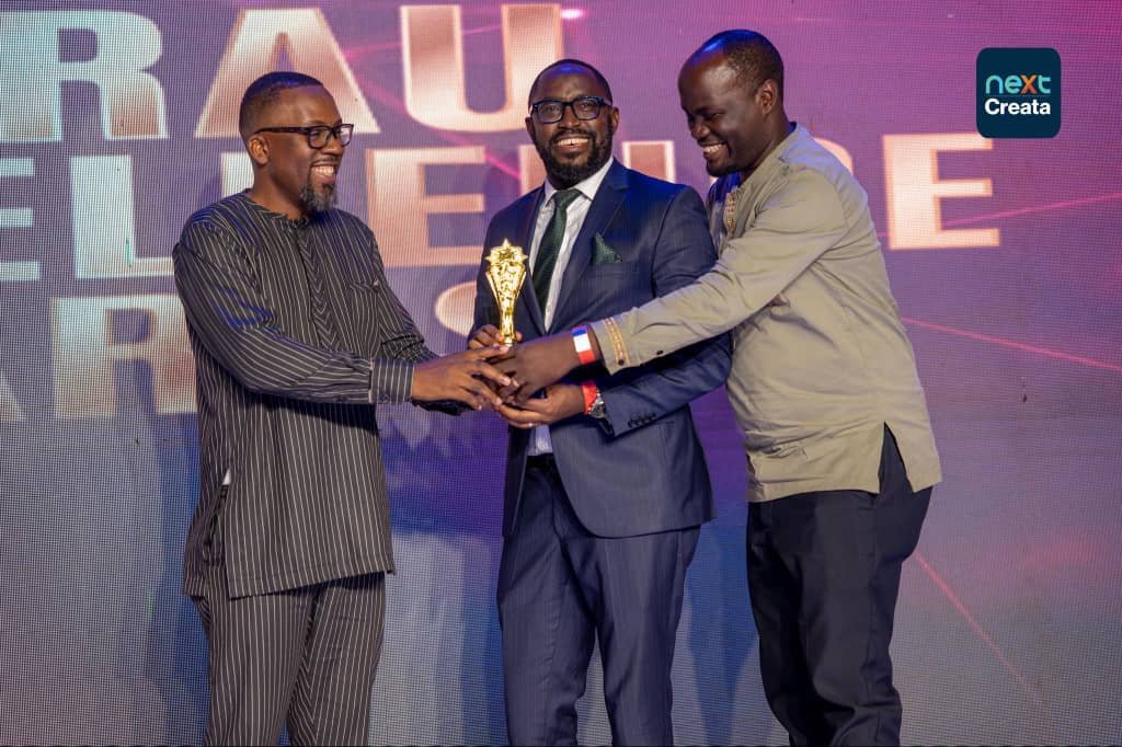 President of the Uganda Advertising Association, Rommel Jasi, presents the Best PR Agency of the Year award to Node Group CEO Ivan Baliboola and Head of PR & Digital, Node.